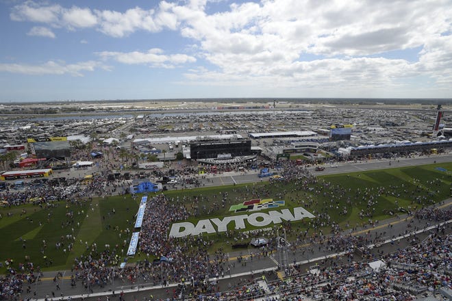 This file photo shows fans on the grass in front of the grandstands of Daytona International Speedway. The motorsports stadium is holding the first of several hiring events on Saturday, June 2, to fill temporary positions for this year's Coke Zero Sugar 400 race weekend in July. [Associated Press file]
