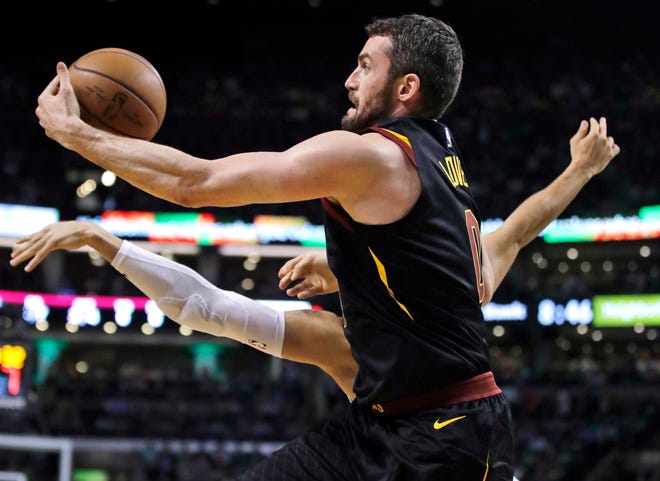 Cleveland Cavaliers center Kevin Love (0) grabs a pass against Boston Celtics forward Jayson Tatum during Game 5 of the NBA basketball Eastern Conference finals in Boston, Wednesday, May 23, 2018. (AP Photo/Charles Krupa)