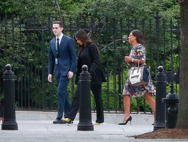 Kim Kardashian, center, arrives at the security entrance of the White House in Washington, Wednesday, May 30, 2018. (AP Photo/Pablo Martinez Monsivais)