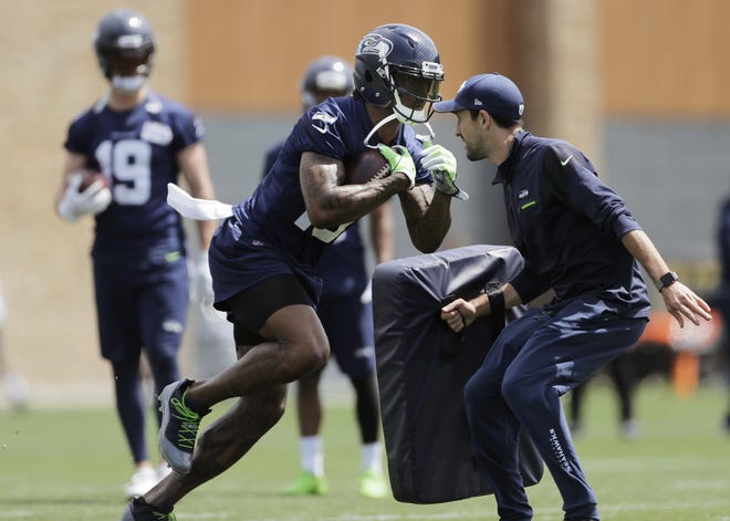 Seattle Seahawks wide receiver Brandon Marshall, center, runs a drill during a practice Wednesday in Renton, Wash. [AP Photo/Ted S. Warren]