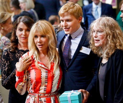 Pulitzer Prize winner for public service Ronan Farrow, second from right, his mother Mia Farrow, far right, Anabella Sciorra, far left, and Rosanna Arquette, second from left, two women accusing Harvey Weinstein of sexual misconduct, arrive for the 2018 Pulitzer Prize winners awards luncheon at Columbia University, Wednesday May 30, 2018, in New York. (AP Photo/Bebeto Matthews)