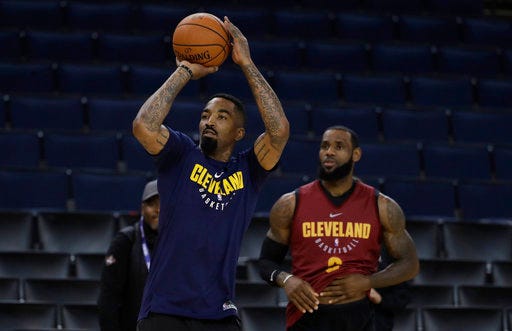 Cleveland Cavaliers' J.R. Smith, left, shoots as his teammate LeBron James watches during an NBA basketball practice, Wednesday, May 30, 2018, in Oakland, Calif. The Cavaliers face the Golden State Warriors in Game 1 of the NBA Finals on Thursday in Oakland. (AP Photo/Marcio Jose Sanchez)