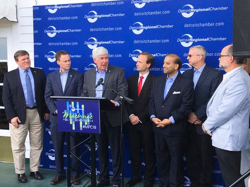 Gov. Rick Snyder, Lt. Gov. Brian Calley, legislative leaders and others announce the commitment of $50 million in state funding to help build a second large lock at Sault St. Marie, Mich., on Wednesday, May 30, 2018, at the Detroit Regional Chamber's Mackinac Policy Conference on Mackinac Island, Mich. State officials are hopeful that by pledging the money, it will help persuade the federal government to fund the proposed project. (AP Photo/David Eggert)