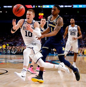 FILE - In this Monday, April 2, 2018 file photo, Villanova's Donte DiVincenzo (10) chases the loose ball against Michigan's Charles Matthews (1) during the second half in the championship game of the Final Four NCAA college basketball tournament in San Antonio. NBA draft decisions by underclassmen will help shape the 2018-19 college basketball season. The winners and losers at the deadline to withdraw from the NBA draft by players who did not hire an agent. (AP Photo/David J. Phillip, File)