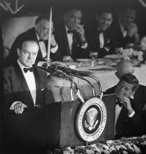 Widely grinning President John F. Kennedy looks up toward comedian Bob Hope in New York's Waldorf-Astoria Hotel on May 30, 1961. [The Associated Press]
