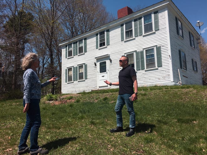Dighton resident Rafa Delfin, seen here talking to Dawn LeCornec, is part of a group that is trying to preserve the historic Nathaniel Crane House on Center Street.

Taunton Gazette photo by Charles Winokoor