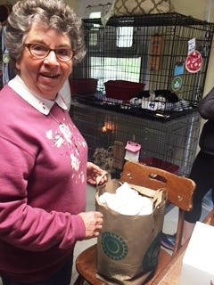 Marblehead Animal Shelter volunteer Linda Greenberg accepts a donation of sheets and towels.

[Courtesy photo]