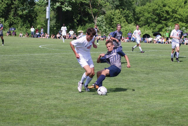 Nate Friesen of DC-G battling for the ball against the Xavier defender during round one of the state soccer tournament, Thursday, May 31. PHOTO BY ANDREW BROWN/DALLAS COUNTY NEWS