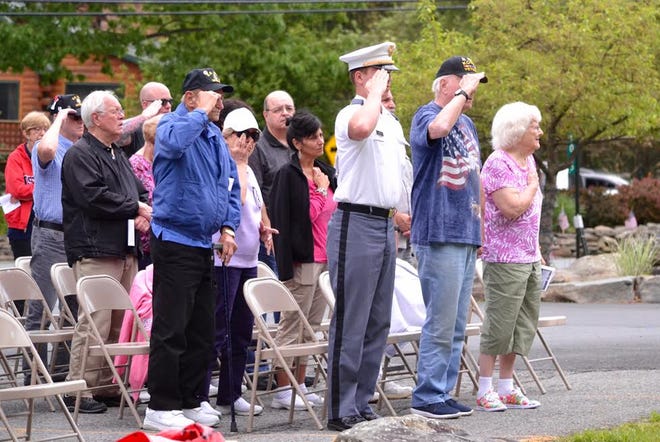 At a Memorial program held in the Wallenpaupack Lake Estates May 28, those in attendance stood for the Pledge of Allegiance with a few who have served standing at attention. See the related photo gallery. News Eagle photo by Katie Collins