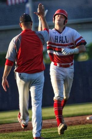 Hall’s Brant Vanaman gets a high five as he rounds third base after hitting a monstrous home run during the Red Devils’ 12-0 five inning win over Brimfield/Elmwood in the Class 2A supersectional Monday night at Augustana College. STEVE DAVIS/GATEHOUSE MEDIA ILLINOIS