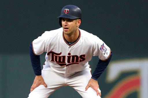 FILE - In this April 12, 2018, file photo, Minnesota Twins' Joe Mauer takes a lead at first in the team's baseball game against the Chicago White Sox in Minneapolis. Mauer has not been able to shake the concussion-like symptoms he has been experiencing since hurting his neck three weeks ago. Mauer's return to the lineup hit another roadblock while working out Thursday, May 31, before Minnesota's game against Cleveland, with more sensitivity to light and noise. The 35-year-old has also been dealing with a cervical strain resulting from a dive for a foul ball on May 11. He played for another week before departing mid-game on May 18. (AP Photo/Jim Mone, File)
