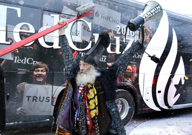 Vermin Supreme, a past presidential candidate, raises his arms as the bus of Sen. Ted Cruz, R-Texas, rolls away after a 2016 campaign event in Manchester, N.H. Supreme is a performance artist who is perennially on the ballot supporting laws mandating dental hygiene and promising a free pony to every American. [2016 file photo/The Associated Press]