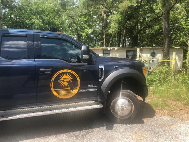 A number of police units, including Florida Department of Law Enforcement, work a crime scene at Caryville residence 726 Wrights Creek Road (County Road 179) today. [Jacqueline Bostick | The News]
