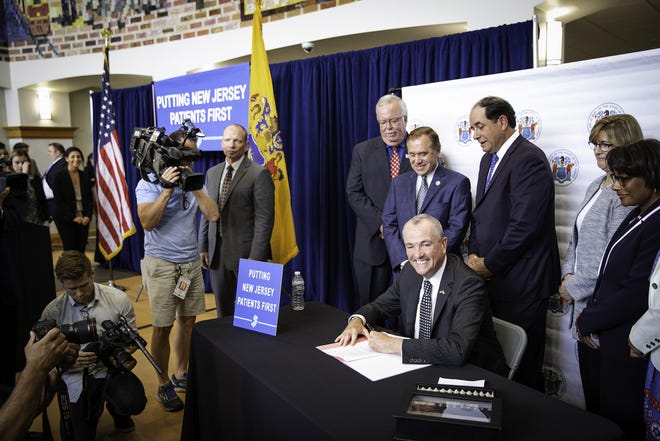 Gov. Phil Murphy signs a bill to fight high out-of-network medical expenses by increasing transparency requirements on health care and insurance providers and strengthening consumer protections in Woodbridge on Friday. [COURTESY OF NJ GOVERNOR'S OFFICE]