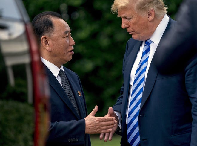 President Donald Trump shakes hands with Kim Yong Chol, former North Korean military intelligence chief and one of leader Kim Jong Un's closest aides, as after their meeting in the Oval Office of the White House in Washington Friday. [ANDREW HARNIK/ASSOCIATED PRESS]