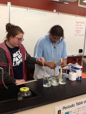 Students Bailey Houston, 14, and Jovan Kimbrough, 14, participate in an experiment in eighth grade science teacher Abby Richenberger's classroom at Edward Stone Middle School. The students were testing whether toilet paper or flushable wipes broke down better when they mimicked the conditions of a toilet. [submitted]