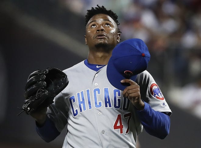Chicago Cubs relief pitcher Randy Rosario look skyward as he walks off the field at the end of the sixth inning of Friday's game against the New York Mets. [AP Photo/Julie Jacobson]