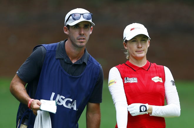Sarah Jane Smith and her caddie husband, Duane Smith, talks about her tee shot on the 18th hole during the second round of the U.S. Women's Open golf tournament at Shoal Creek in Birmingham, Ala. [BUTCH DILL/THE ASSOCIATED PRESS]