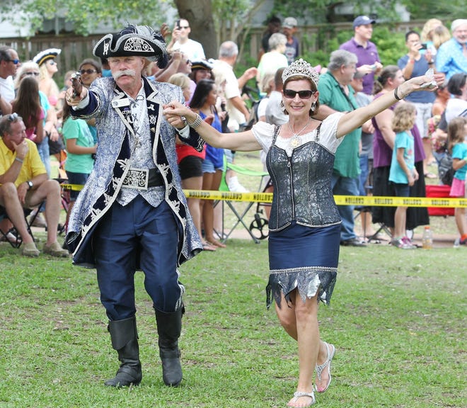 Captain Billy Bowlegs ( Gerry Chalker) and his queen (Tracy McMorrow) arrive during the capture of the city during the 62nd Billy Bowlegs Festival at the Fort Walton Beach Landing. [MICHAEL SNYDER/DAILY NEWS]