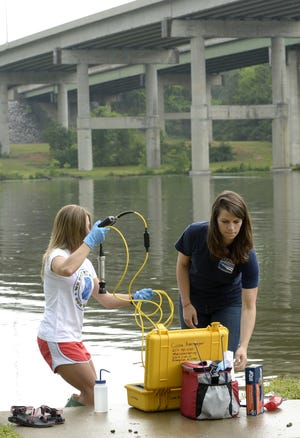Swim Guide intern Kayla Cook, left, and Coosa Riverkeeper Executive Director Justinn Overton test the quality of the water in the Coosa River in 2016 at Jack Ray Park in Gadsden. Area swimming holes continue to register increased E.coli levels after heavy rains in the region. [File/The Gadsden Times]
