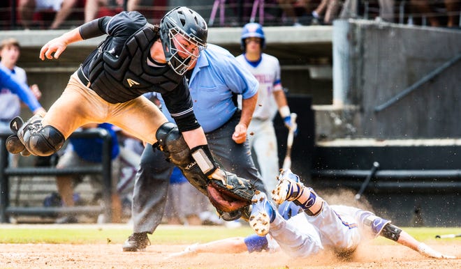 Ledford's Avery Cain (left) attempts a tag on Whiteville's Brooks Baldwin as he safely arrives at home for an inside-the-park home run during their game on Saturday morning at Five County Stadium in Zebulon. [Dan Busey/The Dispatch]