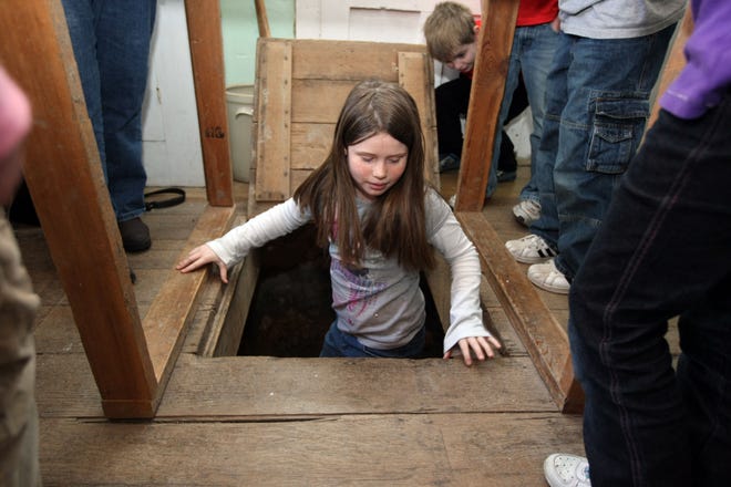 At the Lewelling Quaker Museum in Salem, visitors are able to climb into a space below the kitchen where runaway slaves on the Underground Railway once hid from slave-catchers. [John Lovretta/thehawkeye.com]