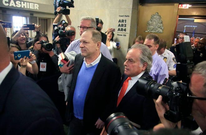 FILE- In this May 25, 2018, file photo, Harvey Weinstein, center, leaves with his lawyer Benjamin Brafman, right, after posting bail at Manhattan's Criminal Court in New York. Brafman was on the winning end of that scenario in 2011 when he helped former International Monetary Fund director Dominique Strauss-Kahn beat an attempted rape charge. Seven years later, Brafman has an even bigger challenge: defending Weinstein against sex crime charges. (AP Photo/Bebeto Matthews, File)