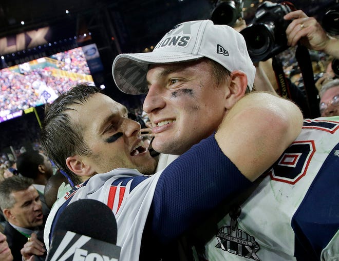 Patriots quarterback Tom Brady, left, and Rob Gronkowski celebrate after the Patriots beat the Seattle Seahawks in Super Bowl XLIX in Glendale, Ariz. [Kathy Willens/AP]