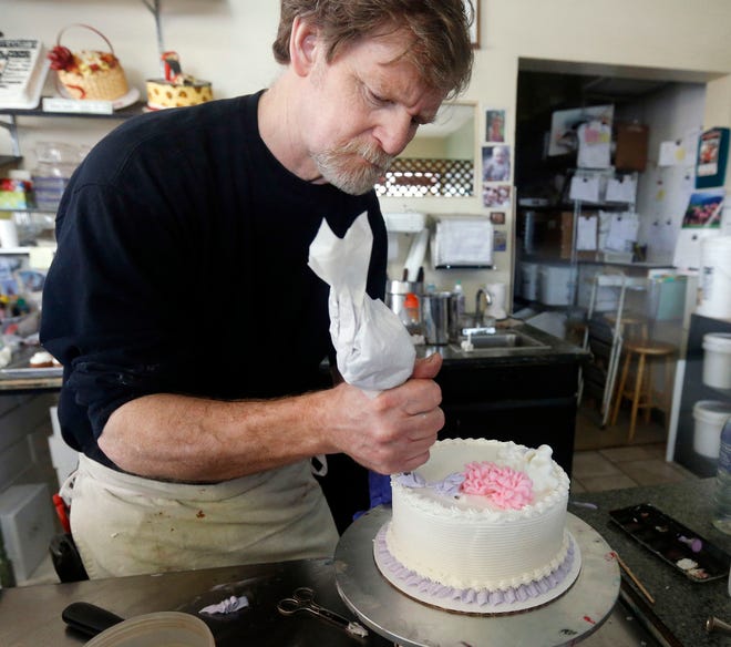 In this March 10, 2014, file photo, Masterpiece Cakeshop owner Jack Phillips decorates a cake inside his store in Lakewood, Colo. The Supreme Court is setting aside a Colorado court ruling against a baker who wouldn’t make a wedding cake for a same-sex couple. But the court is not deciding the big issue in the case, whether a business can refuse to serve gay and lesbian people. (AP Photo/Brennan Linsley, File)