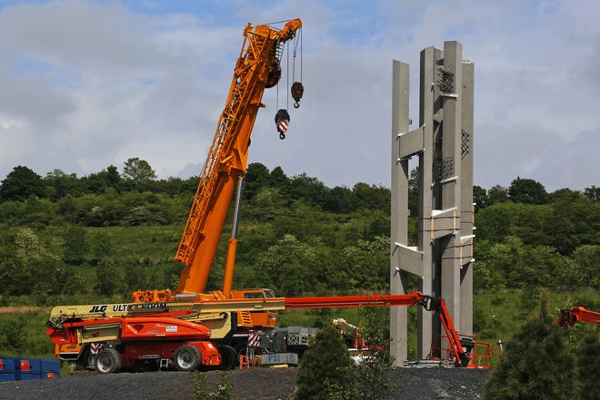 The first section of the 93-foot tall Tower of Voices wind chimes is in place at the Flight 93 National Memorial in Shanksville, Pa on Thursday. The final phase of the memorial is underway and on track to open on the 17th anniversary of plane's crash into a Pennsylvania field during 9/11. [GENE J. PUSKAR/THE ASSOCIATED PRESS]
