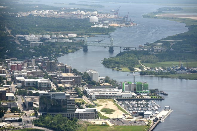 Aerial view of the Cape Fear River winding past downtown Wilmington in June 2017. City council Tuesday is expected to pass a resolution against a proposal to classify 15 miles of the river around the Port City as a swamp. [STARNEWS FILE PHOTO]