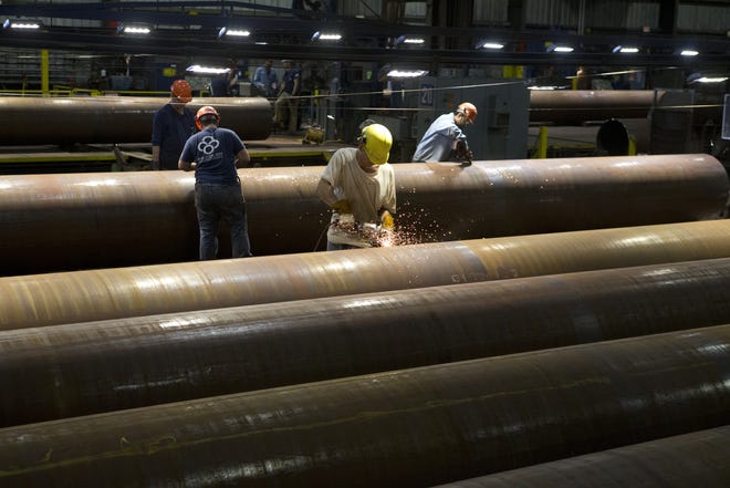 Berg Steel Pipe Corp. workers make steel pipe for oil and gas pipelines at Port Panama City on Friday. [JOSHUA BOUCHER/THE NEWS HERALD]