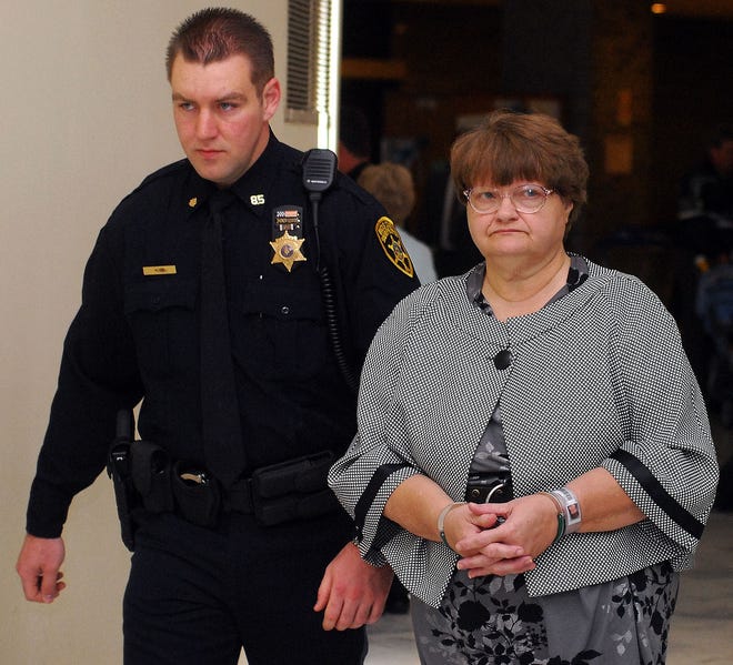 A Bucks County Sheriff's Deputy leads Mary Jane Fonder to the courtroom for the start of her murder trial. As she went past reporters, she said: "I'm the second victim." [FILE]