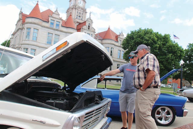 Collin Deardorff, left, chats with Danny Deardorff about one of the vehicles at the Dallas County Sheriff’s All Wheel Show. PHOTO BY ALLISON ULLMANN/DALLAS COUNTY NEWS