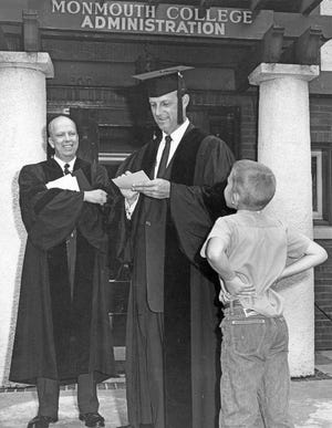 St. Louis Cardinals great Stan Musial signs an autograph for a young fan on the day he was awarded an honorary degree from Monmouth College in 1962.