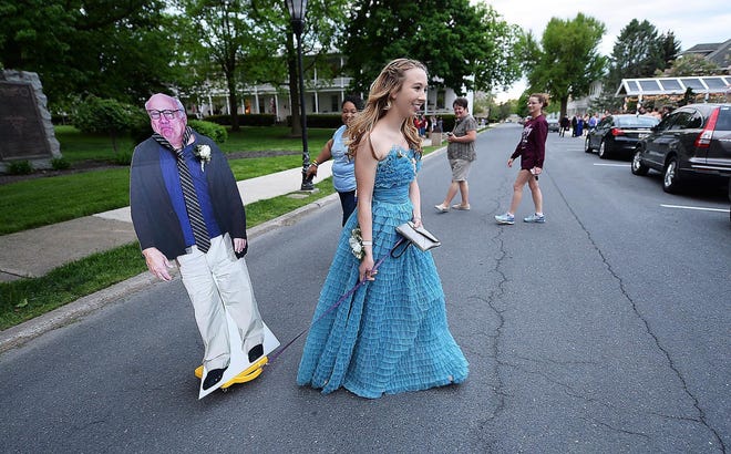 Allison Closs arrives for the Carlisle High School senior prom at Letort View Community Center at Carlisle Barracks in Carlise, Pa., on Friday, May 11, 2018. Closs and her famous two-dimensional date joined other Carlisle High School seniors Friday for prom. Closs purchased the cutout of DeVito online along with a scooter she used to move the figure with.  (Michael Bupp /The Sentinel via AP)