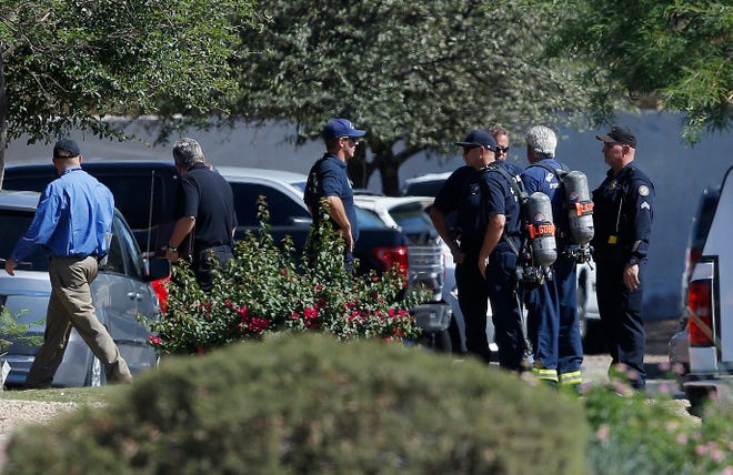 Emergency personnel surround a hotel where a suspect wanted in multiple killings was staying Monday, June 4, 2018, in Scottsdale, Ariz. According to police, the suspect killed himself as police closed in on the hotel. (AP Photo/Ross D. Franklin)