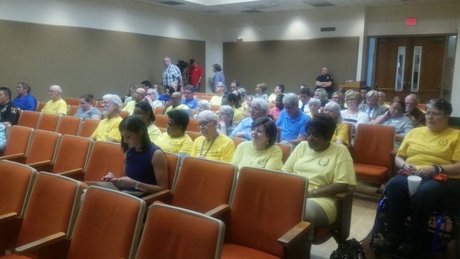 Members of the faith-based organization Topeka JUMP, wearing yellow T-shirts identifying them as being involved with that organization, sat in the audience at Tuesday evening's meeting of the Topeka City Council. [Tim Hrenchir/The Capital-Journal]
