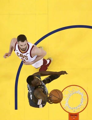 Golden State Warriors forward Draymond Green, bottom, dunks in front of Cleveland Cavaliers forward Kevin Love during the first half of Game 2 of basketball's NBA Finals in Oakland, Calif., Sunday, June 3, 2018. The Warriors won 122-103. (Ezra Shaw/Pool Photo via AP)