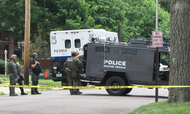 GATEHOUSE MEDIA ILLINOIS The Peoria Bomb Squad responds to the 1300 block of Broadway Street in Pekin after a possible bomb was found during the execution of a search warrant.