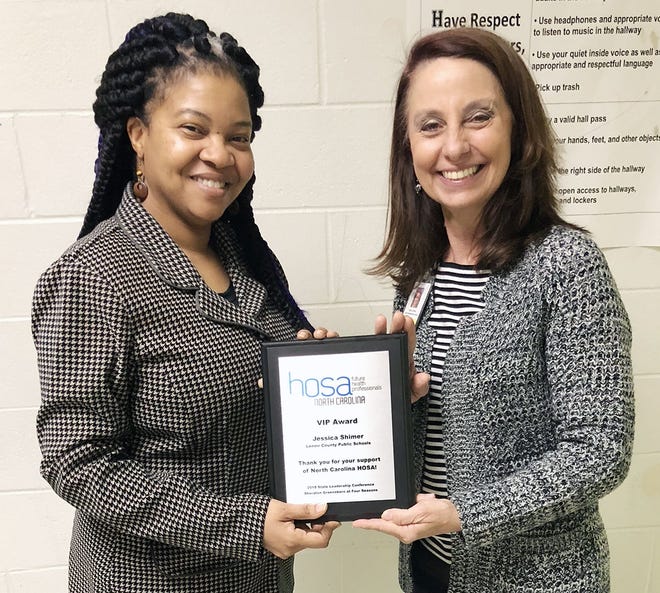 LCPS Career Development Coordinator Jessica Shimer, right, displays her VIP Award from NC HOSA with Kinston High School health science teacher Crystal Payton-Demry, who nominated Shimer for the statewide honor. [Submitted photo]