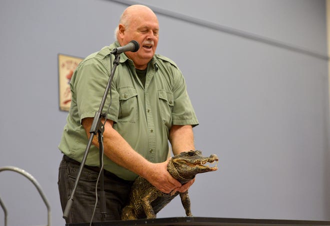John Storms introduces Crocky the crocodile during his World of Reptiles Show at the Leesburg Public Library on Monday, June 20, 2016 in Leesburg, Fla. Storms travels with his reptilian friends to educate children about reptiles and answer any questions they may have. Storms typically brings seven of his pets with him for the demonstration, and hopes by introducing youths to these creatures that they will advocate for them in the future. (Amber Riccinto/ Daily Commercial)