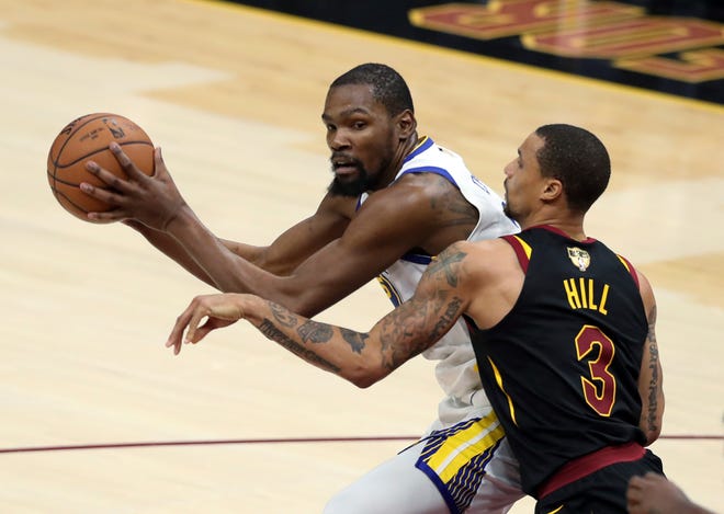 Golden State's Kevin Durant is defended by Cleveland's George Hill in the NBA Finals on Wednesday in Cleveland. [Associated Press/Carlos Osorio]
