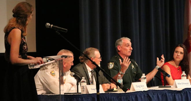 Nearly three months after a March 22 News-Journal town hall on school safety, Volusia County officials — including Sheriff Mike Chitwood, center — are still throwing their arms into the air with no agreement about how to meet a state mandate to have armed security at every school. [News-Journal File]