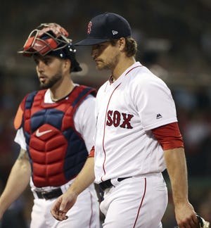 Boston starting pitcher Jalen Beeks walks from the mound with catcher Blake Swihart after the fourth inning Thursday at Fenway Park. [Elise Amendola/AP]