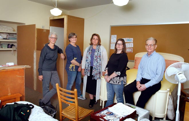 From left are members of the First Unitarian Church's sanctuary committee: Judy Ortman, Katherine Ahlquist, the Rev. Liz Lerner Maclay, Cynthia Rosengard and Jay Glasson. They're gathered in the room they will offer to undocumented immigrants facing deportation. [The Providence Journal / Kris Craig]