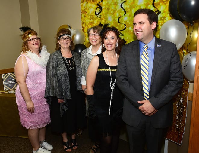From left, are Theresa Widmer, Joan Penix, Nancy Murray, Paula Baughman, and Portage County Commissioner Mike Kerrigan at the celebration for Home Instead Senior Care.