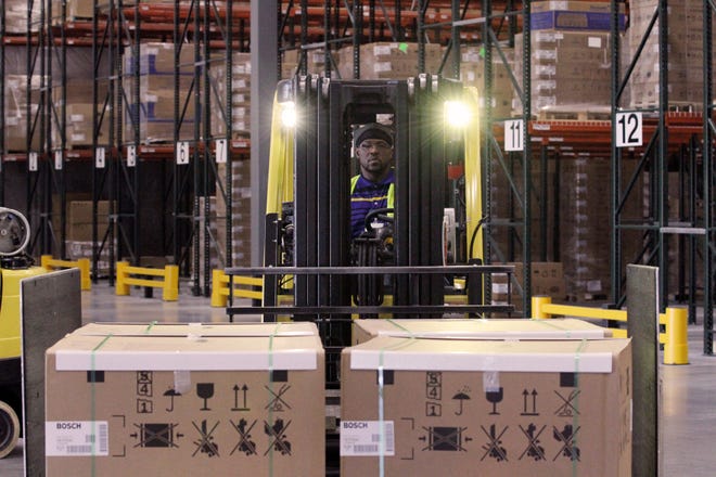 A BSH employee works at the new BSH Home Appliances Central Distribution Center facility that opened in 2017. The new warehouse adds about 359,000 square feet to the current facility, bringing the total to 954,000 square feet. BSH Home Appliances employs close to 1,100 people at its New Bern facilities. [GRAY WHITLEY / SUN JOURNAL STAFF]