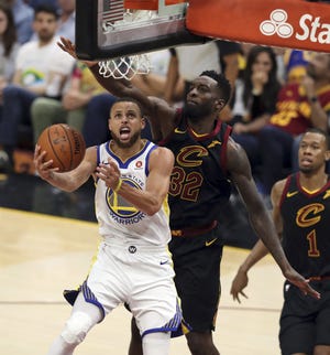 Golden State's Stephen Curry goes up for two in front of Cleveland's Jeff Green during Game 4 of the NBA finals. The Warriors swept the Cavs. [AP photo]