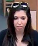 Police are asking for the public's help in identifying a woman who recently cashed two fraudulent checks — totaling $13,702 — at separate TD Bank branches. [Photo provided / Winter Haven Police Department]